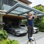 Structural laminated glass canopy installed over a modern landed property car porch in Singapore